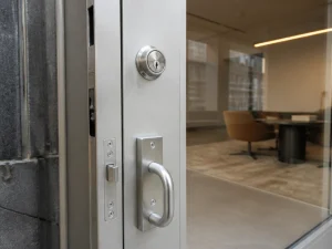 Commercial locksmith in Chelsea installing commercial grade office lock